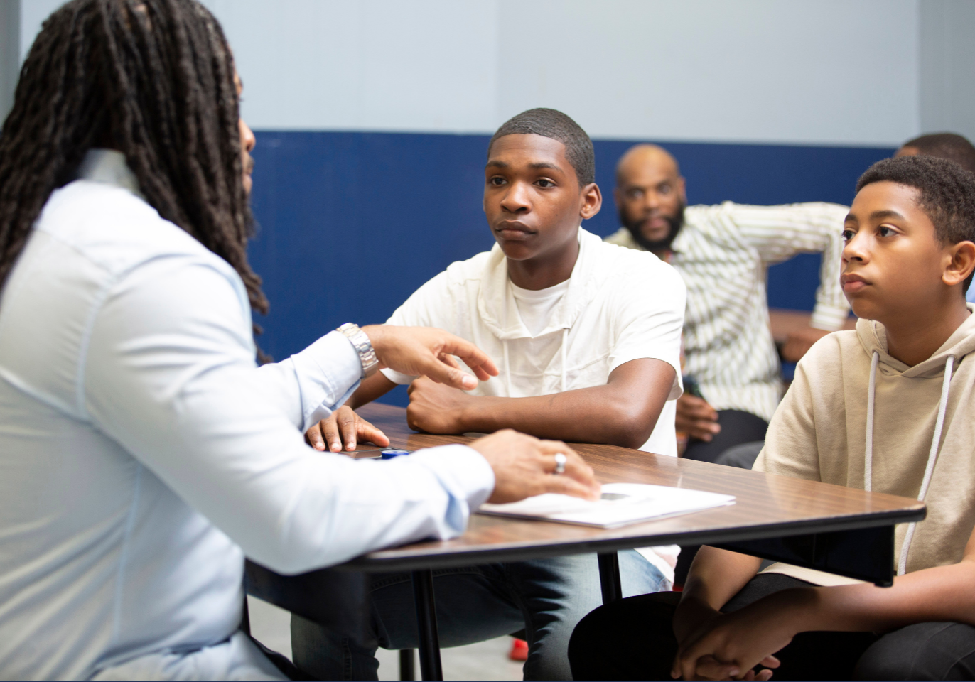 Young man with two young men mentoring